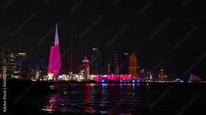 Video Middle East illuminated Doha city skyline at night with Modern skyscrapers near the marina, bay, port,Qatar