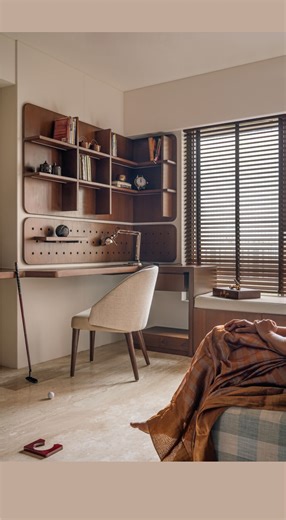 Space Karma on Instagram: "Who said a study table has to play by the rules? In the guest room, this L-shaped wooden study table is more than just a spot to work. Its modular pegs and adjustable shelves let it bend, shift and grow with whatever the moment demands, from focused work hours to fun creative moments. It is flexible, family friendly, and designed to make getting things done feel effortless. Flexible enough to match your work and your whims. Photography by: @mkgandhi_studio | Stylist: @