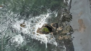 Waves breaking on a sea stack at Copper Coast W,seastack,aterford at low tide on a July day