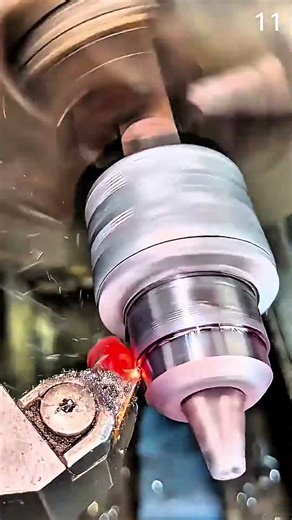 Turning metal cylinder on lathe with cutting tool