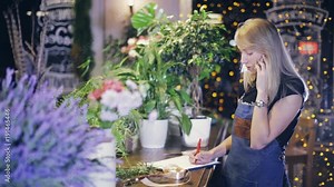 girl florist talking on the phone and writing
