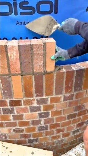 building a neat brick wall using brown bricks and wet cement very carefully #shorts