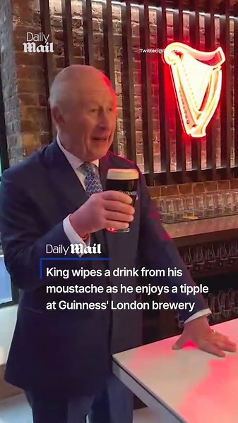 King wipes froth from his lip as he enjoys a pint at Guinness factory