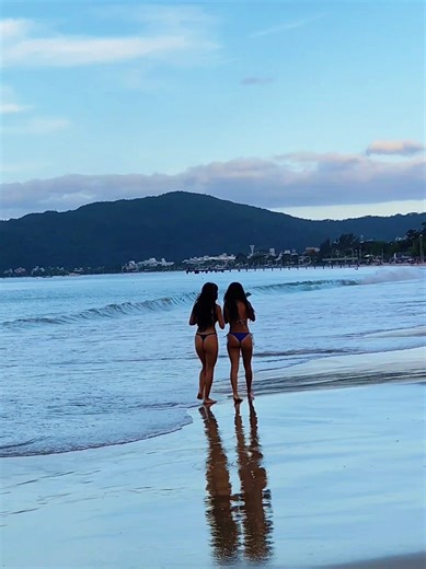 Serene Beach Walk: Women Enjoying Coastal Bliss