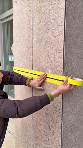 Using duct tape to measure a wall and brickwork that has been installed as a wall compaction gauge