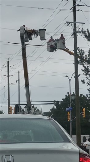 Diligent Hard working High wire electrical workers doing a very dangerous job.
