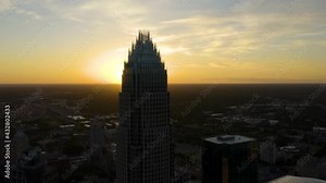 Aerial View of Skyscraper in Downtown Charlotte, North Carolina during Dramatic Sunrise. Orbiting Shot