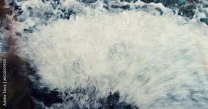 fast flowing river. cinematic looking river background. close up of water flowing over a rock. whitewater from a waterfall. river spray close up. water flowing from the water