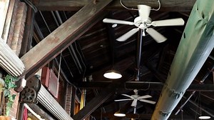 Ceiling of old building with fans spinning
