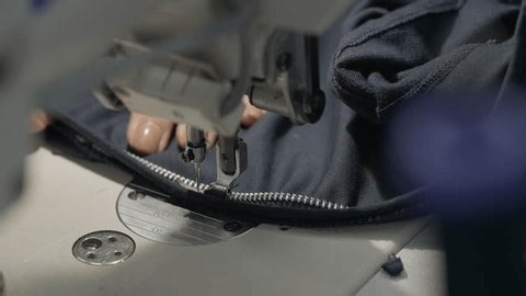 clip-4027698883-close-sewing-machine-stitching-metal-zipper-onto