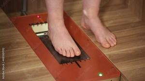 Special orthopedic equipment for feet examination. Female patient staying barefoot on transparent glass surface. Problems with flat-foot and health Stock Video