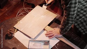 Using roller to prime a demonstration banner. Crafting stuff for a protest meeting