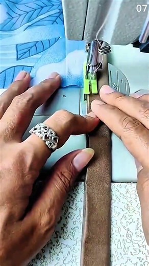 Guiding brown fabric smoothly through sewing machine