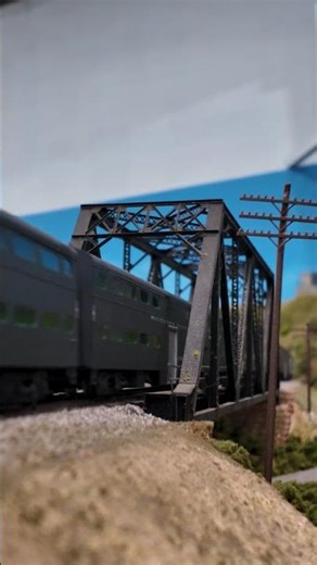 The SP Commute speeds across the bridge at Dresser in HO scale