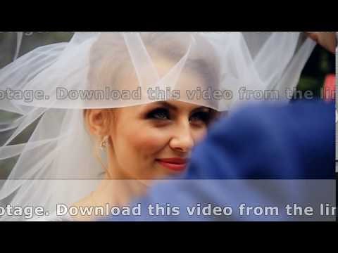 Groom lifting veil off beaming brides face on their wedding day shot in slow motion close up