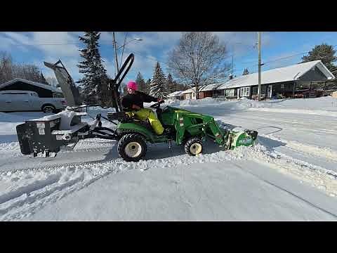 John Deere 1025R pushing snow with HLA 60” pusher