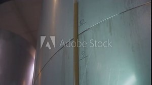 Liter Measuring Marks On Tank Container Filled With Cider Alcoholic Beverage. Liquid In Tube On Industrial Tank Container. Tank Container Filled With Cider Drink By Hose. Production Equipment