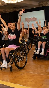 Let’s Celebrate 🎉 There’s so much to do at Rollettes Experience, we always love hearing about our attendee’s experiences each year Have you heard? The tentative schedule for RE23 is now LIVE! RE23 is July 19-23 this year, and we’ve extended the current tuition rate until February 14th! Sign up today with the link in our bio #rollettesexperience #rollettesdance #boundlessbabes #disabilityawareness ••• Video description: Mya sits in front of a wood wall with a neon Rollettes Experience sign and t