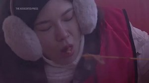 Tourists enjoy hot pots, ice sculptures and even frozen desserts as China's 'ice city' shivers at -22C