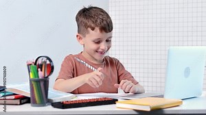 School kid with computer having video conference chat with teacher and class group. Child studying from home. Homeschooling. Modern gadgets for education. Screen time control. Online remote learning.