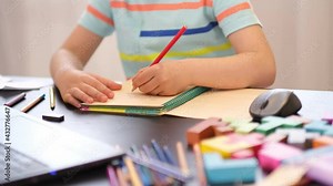 Learn on your schedule. Distance learning online education. A schoolboy boy studies at home and does school homework. A home distance learning.