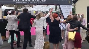 And they're off! Ladies Day revellers on piggy-back through Liverpool