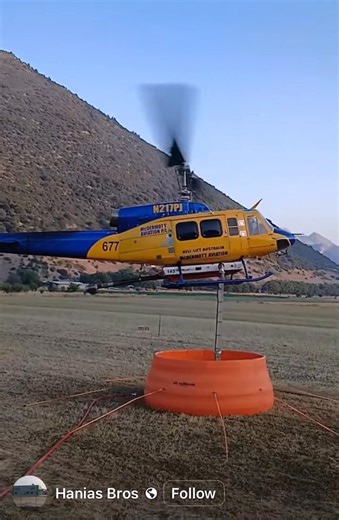 Medium helicopter loading from a relay tank. Watch wildfire videos at Wildfire HQ on YouTube. https://www.youtube.com/@WildfireHQ Purchase Wildfire HQ hoodies here: https://fireground.ca/shop/brands/wildfire-hq/true-north-wildland-hoodie/ | Wildfire HQ