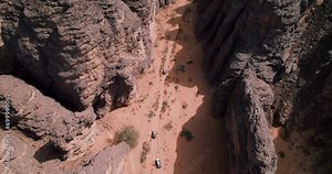 SUV Tour In The Sahara Desert With Sandstone Landscapes In Tassili n'Ajjer National Park, Djanet, Algeria. - aerial shot