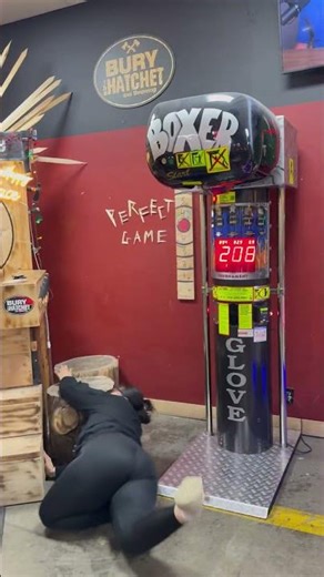 Woman Gives Arcade Boxing Machine Her All and Tumbles Over Logs