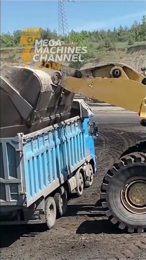 Loader Loading Coal Onto Trucks