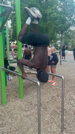 Man Loses Balance During Handstand Push-Up On Parallel Bars