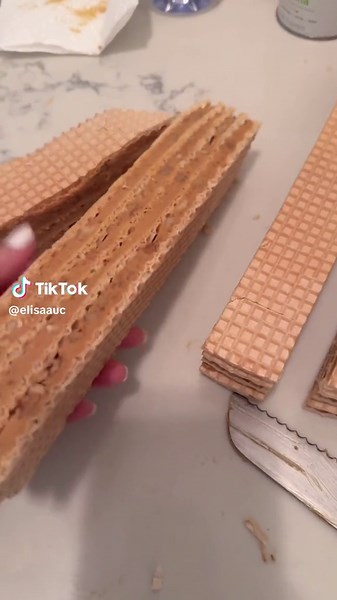 Recipe: Ingredients: - 1 pack European wafer sheets (5 sheets) - 750g dulce de leche - 250g unsalted butter, softened at room temperature - 350g roasted walnuts Instructions: 1. Prepare the Filling: In a mixing bowl, use a hand mixer to beat the softened butter until smooth and creamy. Gradually add the dulce de leche to the butter, continuing to mix until well combined. Stir in the toasted walnuts, making sure they are evenly distributed in the mixture. 2. Assemble the Cake: Lay down the first 