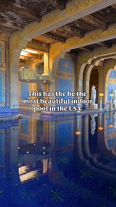 The Roman pool at Hearst Castle was inspired by ancient Roman bathhouses and its walls and floors are covered in deep blue mosaic tiles accented with real gold. There's marble statues and perfect reflections across the water which together make it one of the most luxurious and iconic pools ever built. Hearst castle is in central california and sits on a hilltop in San Simeon with ocean views and zebras roaming the property. As you pass through each room you'll feel transported to different count