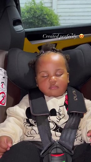 Child in Mickey Mouse Sweatshirt Enjoys Car Ride