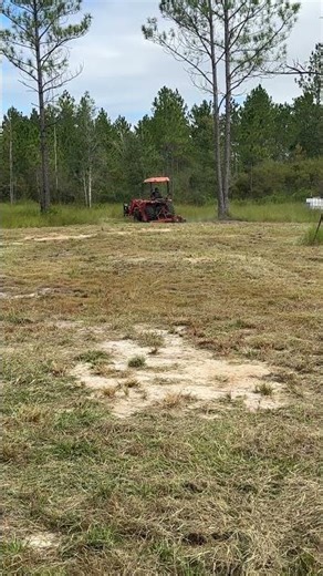 Kubota tractor cutting the grass with a broken bush hog.￼