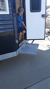 Showing again how the Sure step allows for easier access into your fish house when hooked up! Along with safety when stepping out onto the ice and security when you padlock it shut in the upright position! | Sure Step