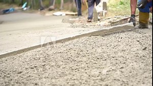 workers make a concrete path in a primitive way