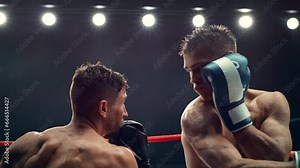 Exciting and Challenging Boxing Match in Super Slow Motion. Boxer Avoiding a Punch and Countering with a Hook to the Jaw, Rocking the Opponent. Cinematic Footage with a Speed Ramp Action Effect