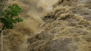 pan up of Wailuku River waterfall flash flooding slow motion