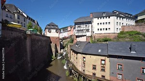 Waterfall in the city center of Saarburg, Germany surrounded by houses on a hill