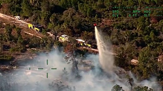 Helicopter drops 2,000 gallons of water to battle blazing brush fire in Ruskin, Florida