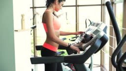 Young healthy woman running on treadmill Full HD