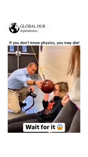 GLOBAL HUB on Instagram: "The post shares a viral video demonstrating pendulum physics, where a bob released from rest stops short of a woman's face due to energy conservation, but swings back to hit a man who pushes it, adding kinetic energy. High engagement (2.2M views, 2.2K likes) stems from its blend of humor and education, echoing classic demos like those in Richard Feynman's lectures on non-conservative forces. Replies debate the mechanics—correctly citing external force disrupting the sys