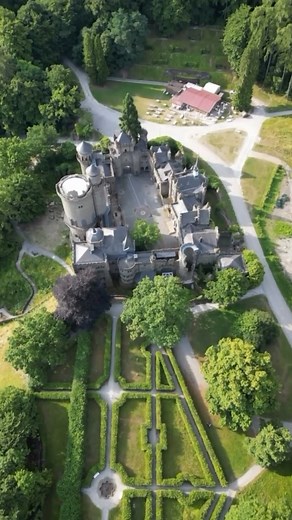 Löwenburg Castle, situated in the Bergpark Wilhelmshöhe—a UNESCO World Heritage Site—above the city of Kassel in Hesse, Germany, is a striking artificial ruin designed to evoke a medieval knight's fortress, though constructed as a Romantic-era pleasure palace between 1793 and 1801. The neo-Gothic structure was masterminded by court architect Heinrich Christoph Jussow using local Habichtswald tuff stone, featuring faux battlements, a keep, drawbridges, an armoury, and a chapel with 13th- to 16th-