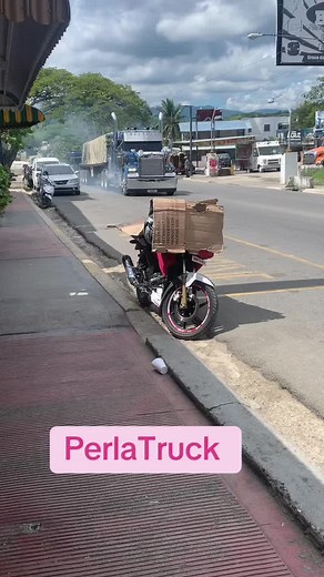 Large Blue Semi-Truck with Cardboard Box in Urban Setting
