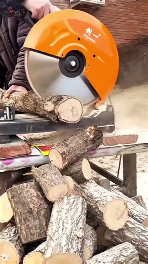 cutting the small wooden logs with a circular saw to create a neat and also even construction result