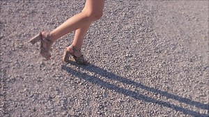 beautiful legs of attractive woman walking at pincio - back view