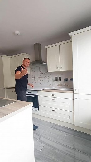 Stylish Modern Kitchen with White Cabinets and Gray Backsplash
