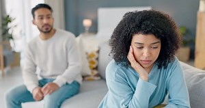 Angry couple and fight with cheating woman thoughtful with regret listening to partner in grief. Frustrated, mad and sad boyfriend conflict with girl for infidelity in home handheld movement.
