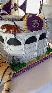 Geaux Tigers! 💜💛 Our Tiger Stadium Groom’s Cake is the ultimate treat for any die-hard LSU fan! 🏟️🐅 This show-stopping cake brings a sweet tribute to Death Valley on the big day—because nothing says Forever LSU like celebrating with a stadium full of flavor! 🎂✨ #TigerStadium #ForeverLSU #GeauxTigers #AmbrosiaBakery | The Ambrosia Bakery